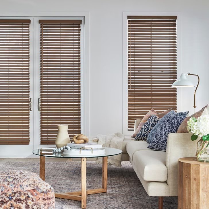 Close view of white faux wood blinds and adjustable slats