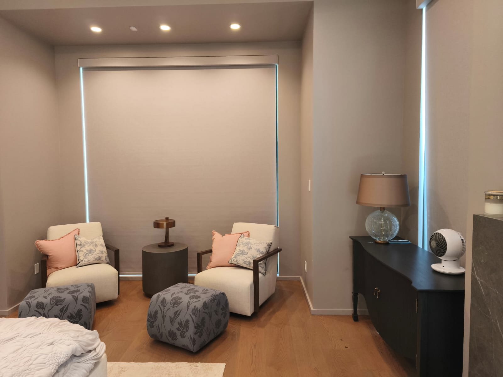 Large roller shade installed in a bedroom sitting area
