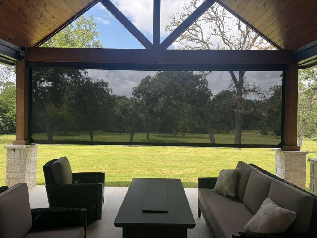 Large exterior screen shade covering an outdoor living area
