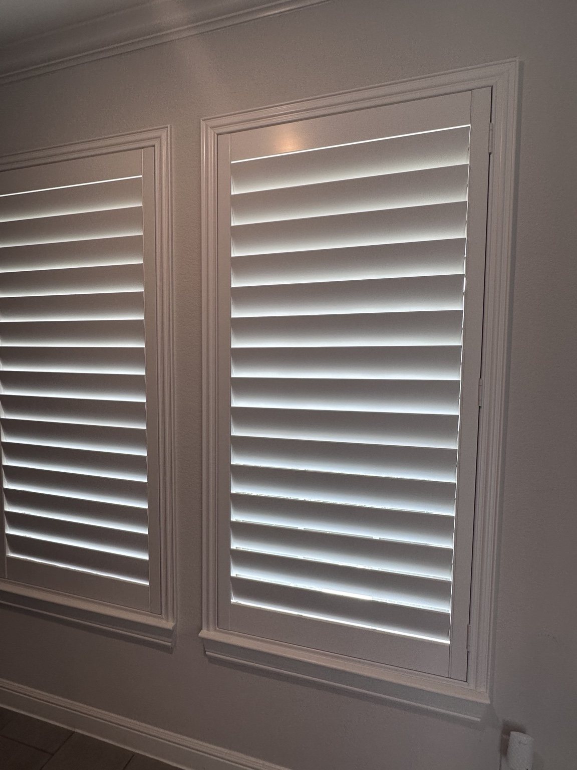 White plantation shutters professionally installed in a home