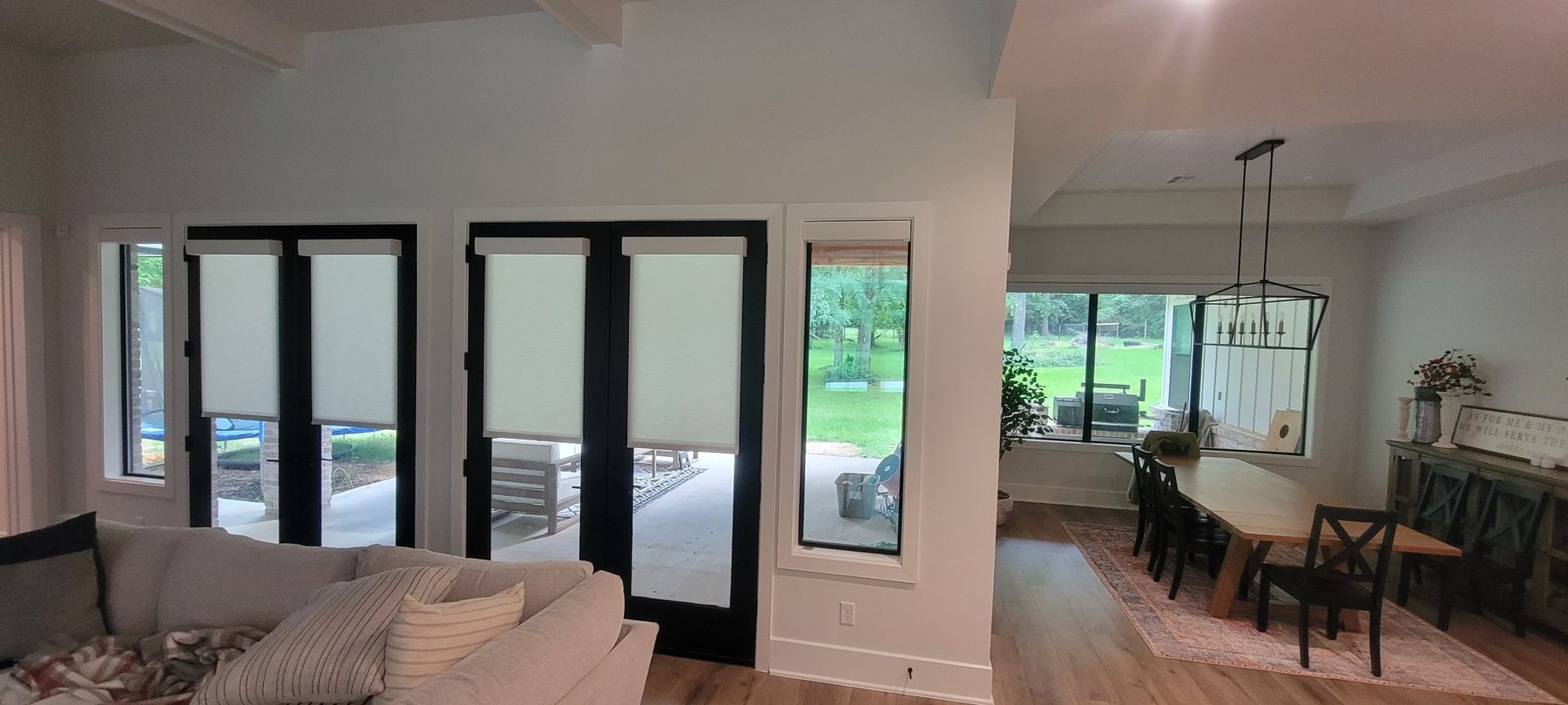 Roller shades installed on French doors and nearby windows